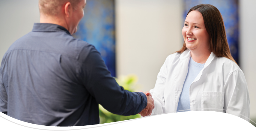 A physician shaking hands with a patient