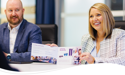 Sam Haney and Kim Gilmore showing off a brochure