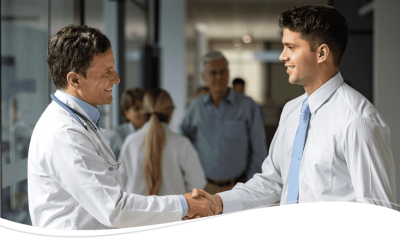 A doctor shaking hands with a salesperson