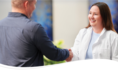 A physician shaking hands with a patient
